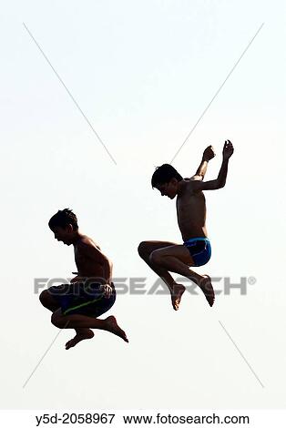 two boys jumping from diving tower to waters of Geneva Lake, Paquis beach, Geneva, Switzerland, Europe View Large Photo Image Stock Photo - two boys jumping from diving tower to waters of Geneva Lake, Paquis beach, Geneva, Switzerland, Europe. Fotosearch