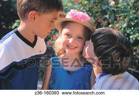 Stock Image - Two boys kissing girl. Fotosearch