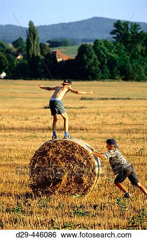 Two boys playing in a field View Large Photo Image Stock Photograph - Two boys playing in a field. Fotosearch