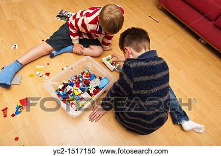 Two boys playing Lego indoors in the Uk View Large Photo Image Stock Image - Two boys playing Lego indoors in the Uk. Fotosearch