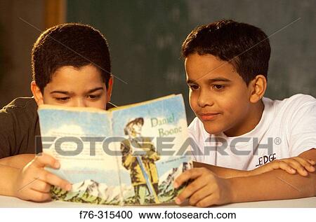 Two boys reading book together View Large Photo Image Stock Image - Two boys reading book together. Fotosearch