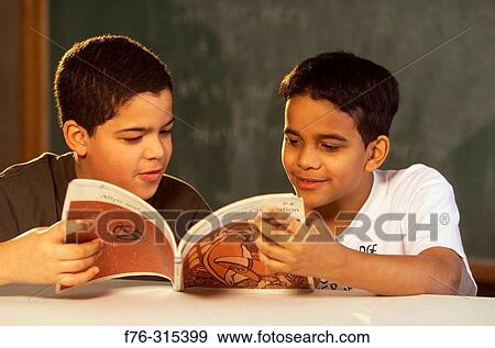 Two boys reading book together View Large Photo Image Stock Photo - Two boys reading book together. Fotosearch