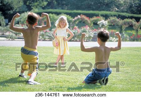 Stock Image - Two boys showing off for girl. Fotosearch