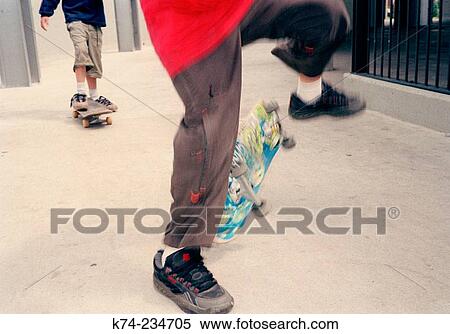 Stock Photography - Two boys skateboarding. Fotosearch