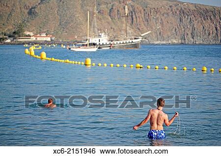 two boys swimming at Los Cristianos beach in Tenerife island spain View Large Photo Image Stock Photograph - two boys swimming at Los Cristianos beach in Tenerife island spain. Fotosearch