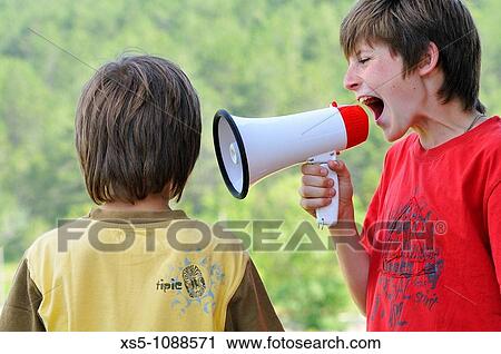 Two boys with a megaphone View Large Photo Image Stock Image - Two boys with a megaphone. Fotosearch