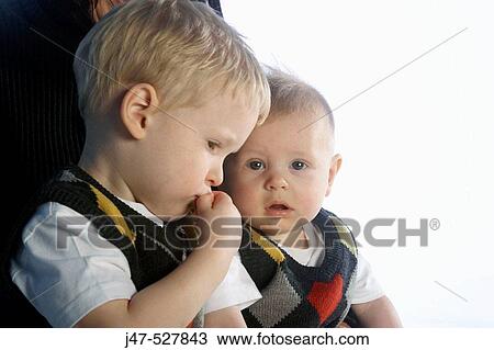 two brothers aged 2 and 6 months, dressed the same, serious View Large Photo Image Stock Image - two brothers aged 2 and 6 months, dressed the same, serious. Fotosearch