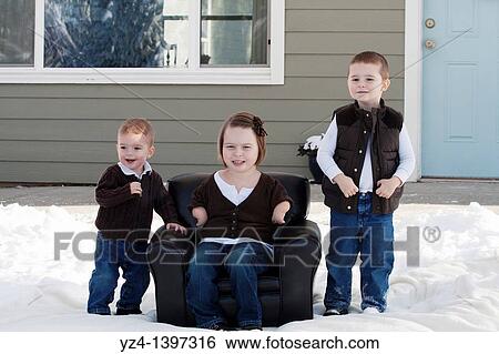 Two brothers and a sister outdoors in the snow View Large Photo Image Stock Photograph - Two brothers and a sister outdoors in the snow. Fotosearch