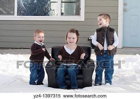Two brothers and a sister outdoors in the snow View Large Photo Image Stock Photography - Two brothers and a sister outdoors in the snow. Fotosearch