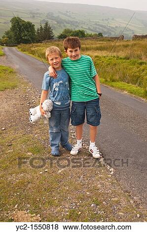 Two brothers walking in Swaledale in North Yorkshire, England, Britain, Uk View Large Photo Image Stock Photo - Two brothers walking in Swaledale in North Yorkshire, England, Britain, Uk. Fotosearch