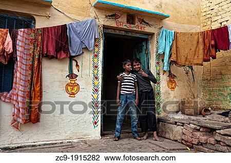 Two children pose at the colorful door of his house, Varanasi, Benares, Uttar Pradesh, India View Large Photo Image Stock Image - Two children pose at the colorful door of his house, Varanasi, Benares, Uttar Pradesh, India. Fotosearch