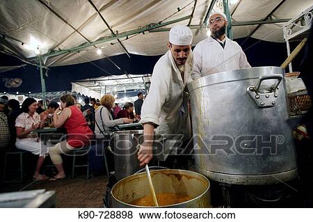 Two cooks cooking traditional corn tomate soup in a foodstall at Jemaa El Fna Square in Marrakech, Morroco, Maghreb, North Africa View Large Photo Image Stock Photo - Two cooks cooking traditional corn tomate soup in a foodstall at Jemaa El Fna Square in Marrakech, Morroco, Maghreb, North Africa. Fotosearch