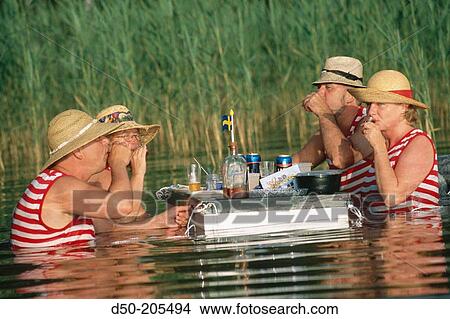 Picture - Two couples dine in water. Lake Vattern. Sweden. Fotosearch