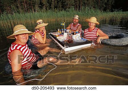 Two couples dine in water. Lake Vattern. Sweden View Large Photo Image Stock Image - Two couples dine in water. Lake Vattern. Sweden. Fotosearch