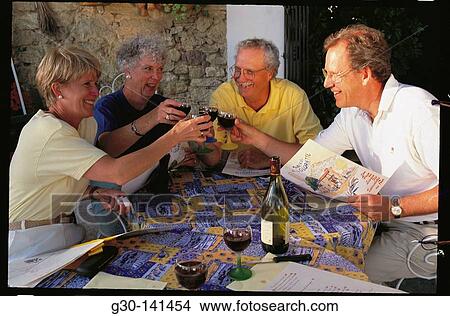 Picture - Two couples drinking wine. Fotosearch