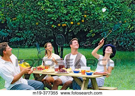 two couples having fun at a picnic table View Large Photo Image Stock Photography - two couples having fun at a picnic table. Fotosearch