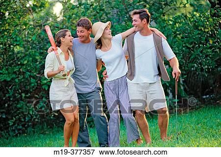 Stock Photo - two couples outdoors having fun together. Fotosearch
