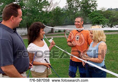 Two couples playing badminton. View Large Photo Image Stock Photo - Two couples playing badminton.. Fotosearch