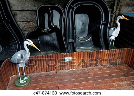 Two decorative Grey heron (Ardea cinerea) on sale in a garden center View Large Photo Image Stock Image - Two decorative Grey heron (Ardea cinerea) on sale in a garden center. Fotosearch