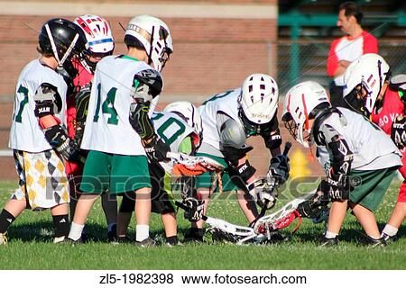 Two elementary school lacrosse teams scramble for the ball during a game. View Large Photo Image Stock Photo - Two elementary school lacrosse teams scramble for the ball during a game.. Fotosearch