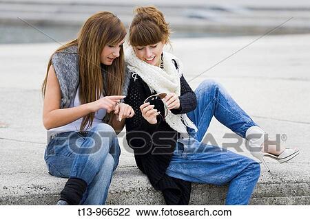 Two fanciful girls are commenting eyeglasses View Large Photo Image Stock Image - Two fanciful girls are commenting eyeglasses. Fotosearch