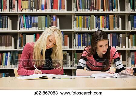 Two female college students studying in a library View Large Photo Image Stock Image - Two female college students studying in a library. Fotosearch
