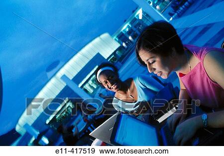 Two female college students with laptop, campus exterior. View Large Photo Image Stock Photo - Two female college students with laptop, campus exterior.. Fotosearch