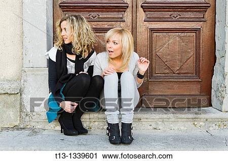 Stock Image - Two female friends pleasantly surprised. Fotosearch
