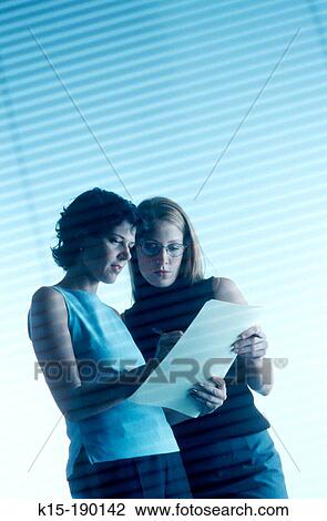 Two female office workers View Large Photo Image Stock Image - Two female office workers. Fotosearch