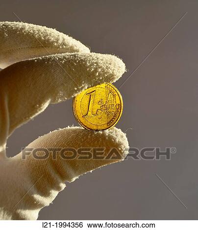 Two fingers protected by a white glove holding a one euro coin. Isolated on grey background. View Large Photo Image Stock Photograph - Two fingers protected by a white glove holding a one euro coin. Isolated on grey background.. Fotosearch