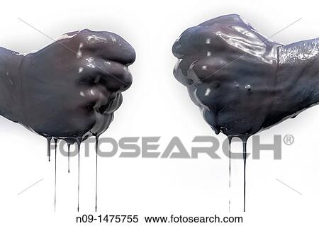 Stock Photography - two fists with dark liquid. Fotosearch