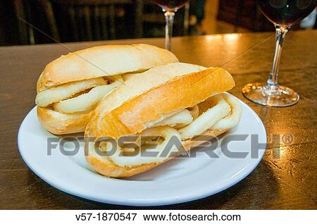 Two fried squids sandwiches in typical tavern. Madrid, Spain. View Large Photo Image Stock Photo - Two fried squids sandwiches in typical tavern. Madrid, Spain.. Fotosearch