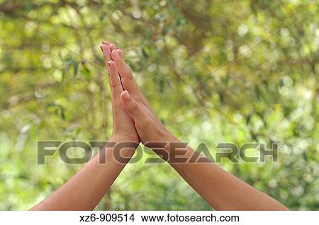 Picture - two friends collide hands in the foreground. Fotosearch