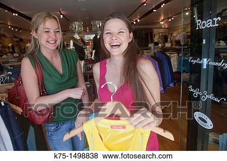 Two friends enjoying a laugh while shopping View Large Photo Image Stock Photo - Two friends enjoying a laugh while shopping. Fotosearch
