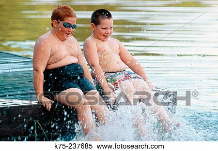Two friends enjoying the water View Large Photo Image Stock Photography - Two friends enjoying the water. Fotosearch