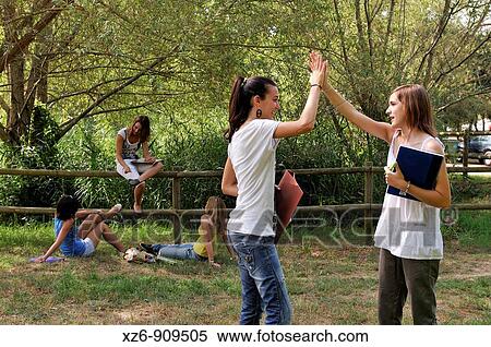 Two friends greet on campus View Large Photo Image Stock Photography - Two friends greet on campus. Fotosearch