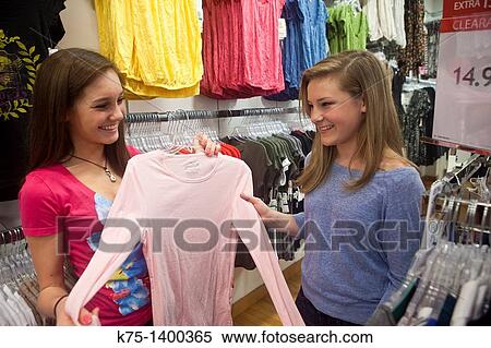 Two friends shopping for clothes View Large Photo Image Stock Photography - Two friends shopping for clothes. Fotosearch