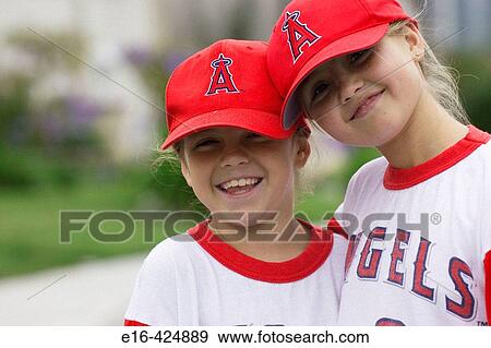 Two girl friends in baseball uniforms View Large Photo Image Stock Photo - Two girl friends in baseball uniforms. Fotosearch