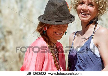 Two girl friends laughing View Large Photo Image Stock Image - Two girl friends laughing. Fotosearch