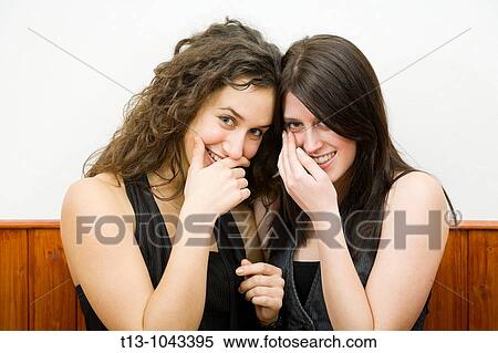 Two girlfriends are smiling View Large Photo Image Stock Photography - Two girlfriends are smiling. Fotosearch