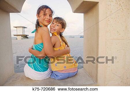 Stock Photograph - two girlfriends hugging. Fotosearch