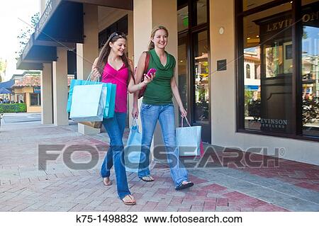 Stock Image - Two girlfriends shopping. Fotosearch