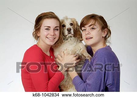Two girls, 14 and 18, in studio with dog View Large Photo Image Picture - Two girls, 14 and 18, in studio with dog. Fotosearch