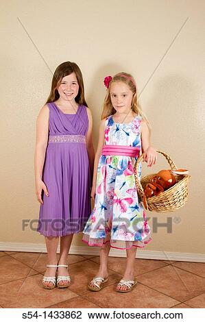 Two girls, 5-10, wearing Easter dresses and holding a basket. View Large Photo Image Stock Image - Two girls, 5-10, wearing Easter dresses and holding a basket.. Fotosearch