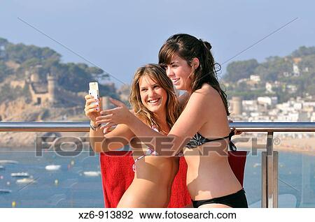 two girls becoming a mobile photos View Large Photo Image Stock Image - two girls becoming a mobile photos. Fotosearch