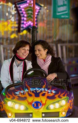 Two girls enjoy their ride in the bumper car at the Bremen Annual Fair in Germany, Europe View Large Photo Image Stock Image - Two girls enjoy their ride in the bumper car at the Bremen Annual Fair in Germany, Europe. Fotosearch