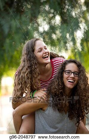 Two girls having fun outdoors. View Large Photo Image Stock Photo - Two girls having fun outdoors.. Fotosearch