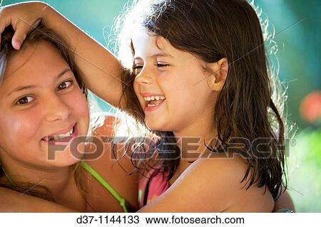 Stock Image - Two girls having fun. Fotosearch