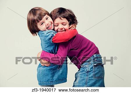 Two girls in a hug. View Large Photo Image Stock Photo - Two girls in a hug.. Fotosearch