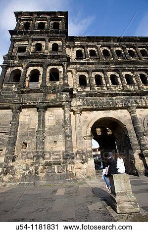 TWO GIRLS IN FRONT OF PORTA NIGRA, THE ROMAN CITY GATE OF TRIER. GERMANY View Large Photo Image Stock Image - TWO GIRLS IN FRONT OF PORTA NIGRA, THE ROMAN CITY GATE OF TRIER. GERMANY. Fotosearch